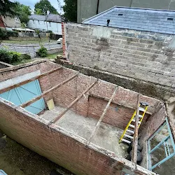 Outbuilding with the asbestos roof removed down to the frame