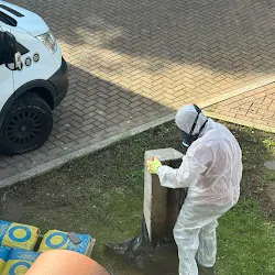 SafeZone operative in a full protective suit removing an asbestos planter